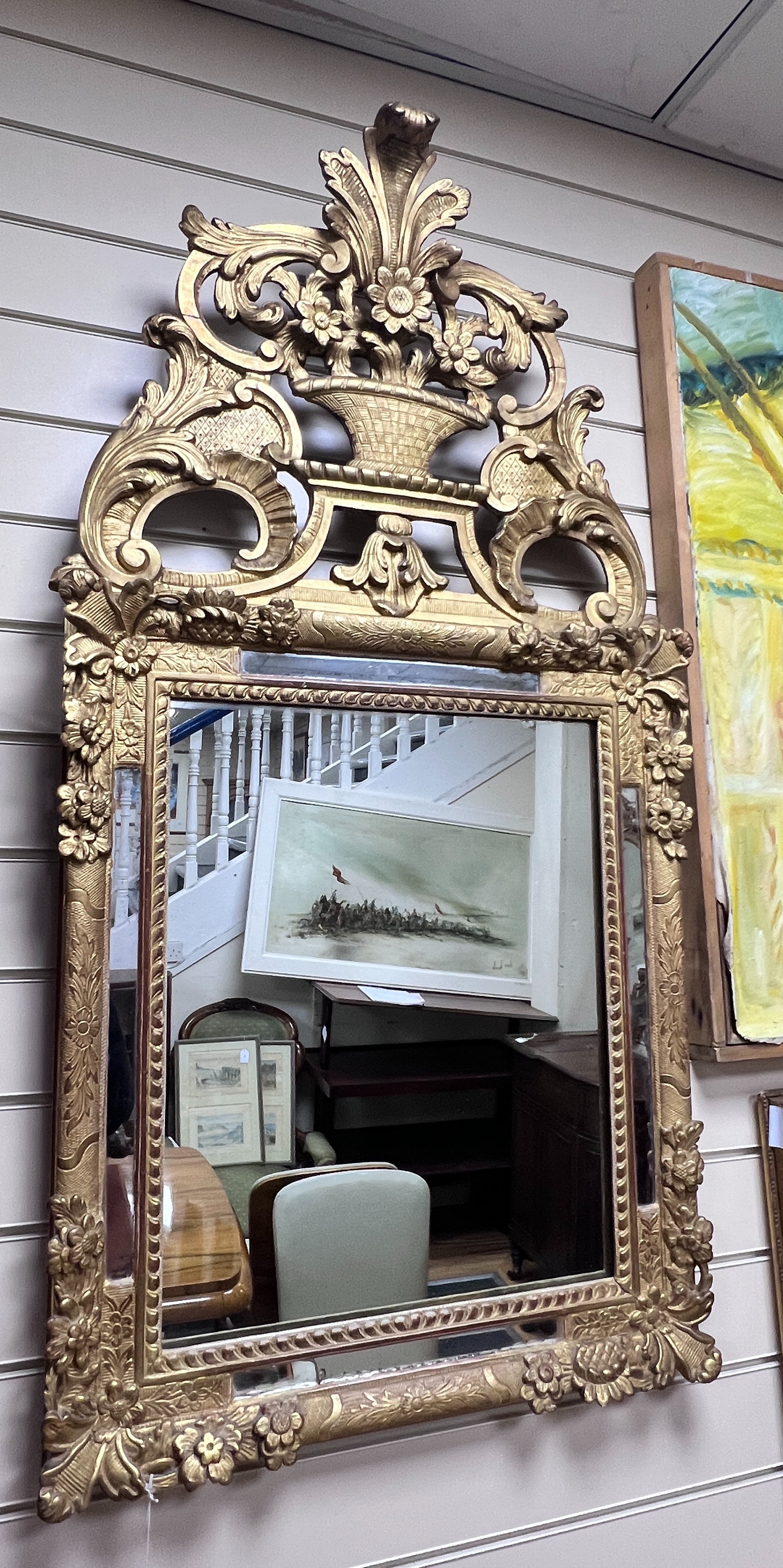 An early 19th century French carved giltwood and gesso wall mirror, W.60cm H.120cm